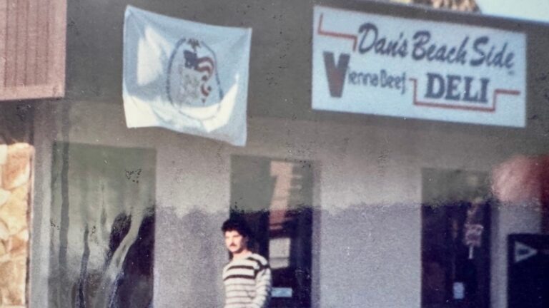 Picture of Dan Casey in front of his first restaurant Dan's Beach Side Deli